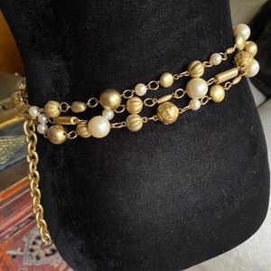 Metal, gold bead, and faux pearl chain belt.